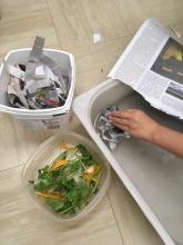 Laying wet newspaper to start a worm compost bin