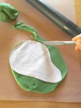 Roll out the playdough and cut it out in the shape of the outer contour line