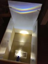 Flashlight shone through cut glass makes a rainbow