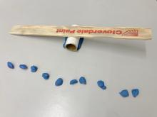 Use clay to balance the paint stick - smaller pieces are easier