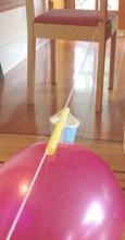 round balloon on string with weight