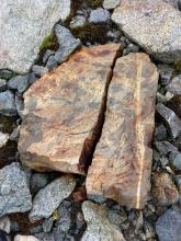 Rock likely weathered by water freezing (red slate Whistler alpine)