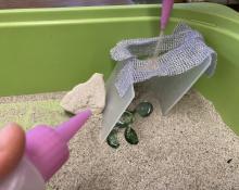 free play: blowing sand at a structure