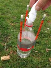 Adding the package of baking soda to the bottle containing vinegar