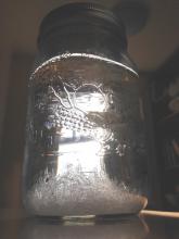 Large crystals formed from slow cooling of Epsom salt solution in a jar