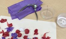 garlic press and tweezers making tissue paper art