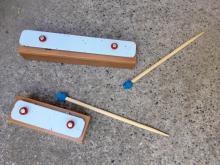 Glockenspiel notes and chopstick mallets. The longer note is lower, the shorter note is higher