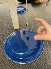 Arrange the magnets on the base to affect the hanging magnet