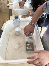 Shake layers of sugar and sand alternately into the tray