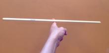 Long stick balanced on a finger