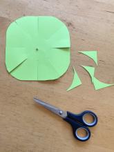 Cut a rough circle out of the cardstock and cut 8 blades