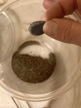 magnet separates out magnetic sand (containing iron)