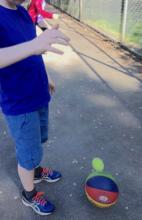 The smaller ball about to bounce really high