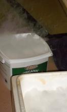 Box of dry ice pellets (front). Dry ice added to water (back).