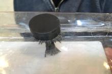 iron filings stack up underneath a magnet