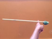 Playdough weight on one end of a long stick